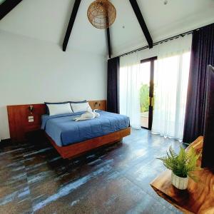 a bedroom with a bed with a blue comforter at Ing Suan pool villa 1 in Ao Nang Beach +15 photos