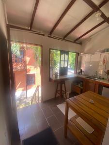 a kitchen with a wooden table and a wooden table sidx sidx sidx at Apartaestudio con balcón cerca al mar in Puerto Colombia