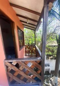 a porch of a house with a wooden fence at Apartaestudio con balcón cerca al mar in Puerto Colombia