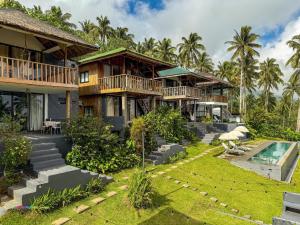 an exterior view of a house with a swimming pool at Bintana sa Paraiso Binunsaran in Mambajao