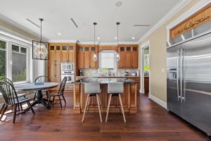 a kitchen with a table and chairs and a refrigerator at Spacious Cozy House in Vancouver West in Vancouver