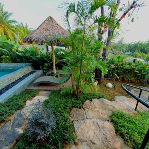 a resort with a pool and a chair and a hut at Ing Suan pool villa 1 in Ao Nang Beach