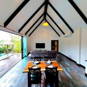 a living room with a couch and a table and chairs at Ing Suan pool villa 1 in Ao Nang Beach