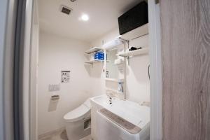 a bathroom with a sink and a toilet at Boa Sorte Hotel AD0515 in Tokyo