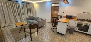 a living room with a couch and a table at The Beleza Suites in Kericho