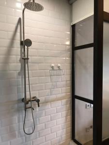 a shower with a shower head in a bathroom at d'primahotel Yogyakarta in Yogyakarta