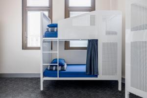 a bunk bed with blue seats in a room at Wake Up! Sydney Central in Sydney +70 photos