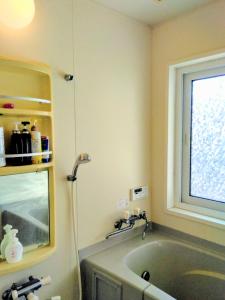 a bathroom with a bath tub and a window at Fuji Hike Stay in Oyama +37 photos