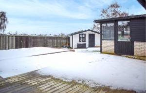 a detached house with a snow covered yard at Beautiful Home In Simrishamn in Simrishamn