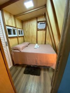 a small bedroom with a bed in a tiny house at Tiny House in Boa Vista