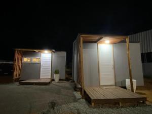 a couple of tiny homes sitting in the dark at Tiny House in Boa Vista
