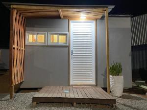 a room with a wooden door and a window at Tiny House in Boa Vista