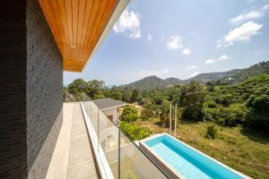a view from the balcony of a house with a swimming pool at Villa M3 De Samui in Nathon Bay