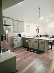 a kitchen with stainless steel appliances and wooden floors at Xscapecatio Oasis II in Tulsa