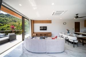 a living room with a couch and a table at Villa M3 De Samui in Nathon Bay