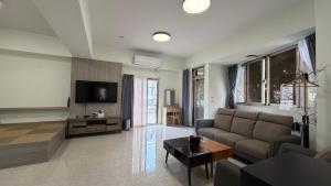 a living room with a couch and a tv at 且市隱 in Hualien City