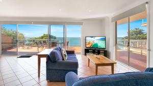 a living room with a view of the ocean at Cowes Beachfront Penthouse in Cowes