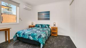 a bedroom with a bed and a window at Cowes Beachfront Penthouse in Cowes