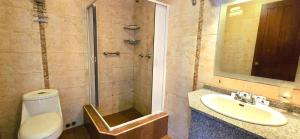 a bathroom with a shower and a toilet and a sink at Hotel Savoy Inn in Quito +22 photos