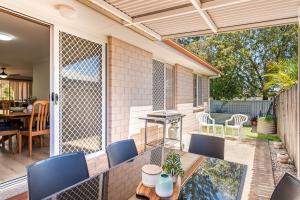 an outdoor patio with a table and chairs at Waratah Retreat in Evans Head