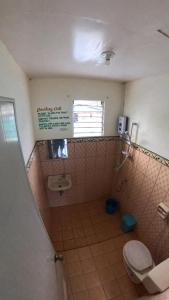 a bathroom with a toilet and a sink at Buena Lynnes Annex Lodge in Puerto Galera +7 photos