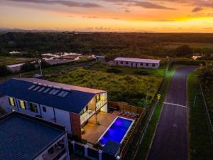 an aerial view of a house with a swimming pool at Tides Apartments in Nadi