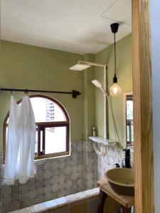a bathroom with a sink and a window at Tiny bright house Autum space in Danang