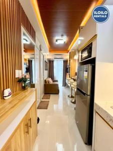 a kitchen and living room of an rv at Modern Style 2-BR in SMDC in Iloilo City