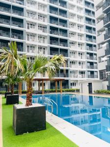 an image of a large apartment building with a swimming pool at Modern Style 2-BR in SMDC in Iloilo City