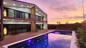 a house with a swimming pool in front of a building at Tides Apartments in Nadi +88 photos