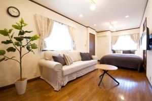 a living room with a couch and a bed at Forest Inokashira in Mitaka
