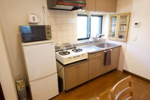 a kitchen with a white stove and a refrigerator at Forest Inokashira in Mitaka +44 photos