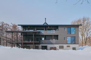 a house in the snow in front at Villa El Cielo Myoko in Myoko