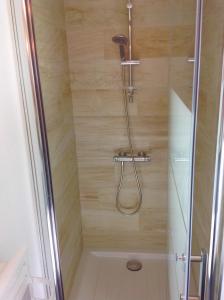 a shower with a shower head in a bathroom at Appartement sur 3 niveaux centre ville CAEN in Caen
