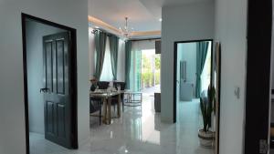 a living room with a table and a dining room at บ้านมั่งมี ขอนแก่น in Ban Si Than