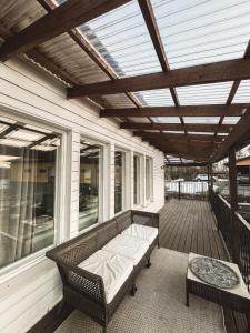 a screened porch with a bench and a table at Beautiful Home in Sipoo in Söderkulla