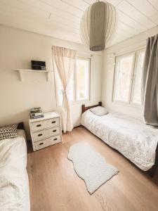 a bedroom with two beds and a window at Beautiful Home in Sipoo in Söderkulla