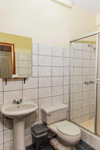 a bathroom with a toilet and a sink at Hotel Oro Verde Iquitos in Iquitos +12 photos