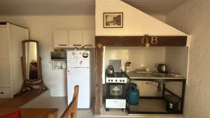 a small kitchen with a stove and a refrigerator at Monoambiente 4 blocks away from the beach! in Paysandú