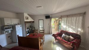 a kitchen and living room with a couch and a table at Monoambiente 4 blocks away from the beach! in Paysandú
