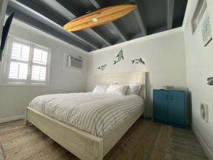 a bedroom with a bed and a wooden ceiling at Tiny home living!! First floor condo! in Panama City Beach