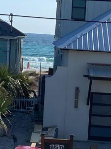 a house with a view of the ocean from the beach at Tiny home living!! First floor condo! in Panama City Beach +3 photos