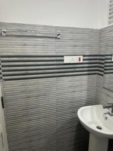 a bathroom with a sink and a toilet and a shower at Solace More Hotel - Borella 2 in Colombo