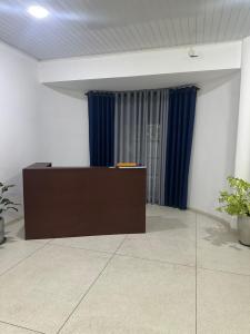 a podium in a room with blue curtains at Solace More Hotel - Borella 2 in Colombo