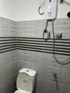 a bathroom with a toilet and a shower at Solace More Hotel - Borella 2 in Colombo