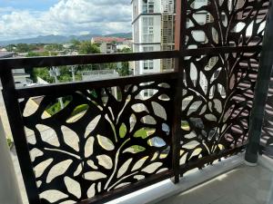 a iron fence with a view of a balcony at Wide studio Antara Residences Talisay in Talisay