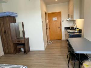 a small kitchen with a sink and a counter at Wide studio Antara Residences Talisay in Talisay
