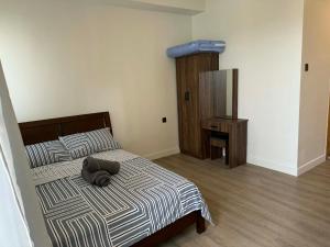 a bedroom with a bed with a pillow on it at Wide studio Antara Residences Talisay in Talisay