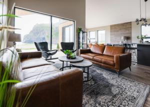 a living room with two couches and a table at Luxury Ocean Villas in Vestmannaeyjar