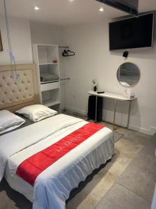 a bedroom with a bed with a red blanket on it at habitat la DHUYS in Montreuil
